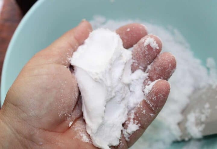 Mixing toilet bomb mixture until it feels like wet sand.