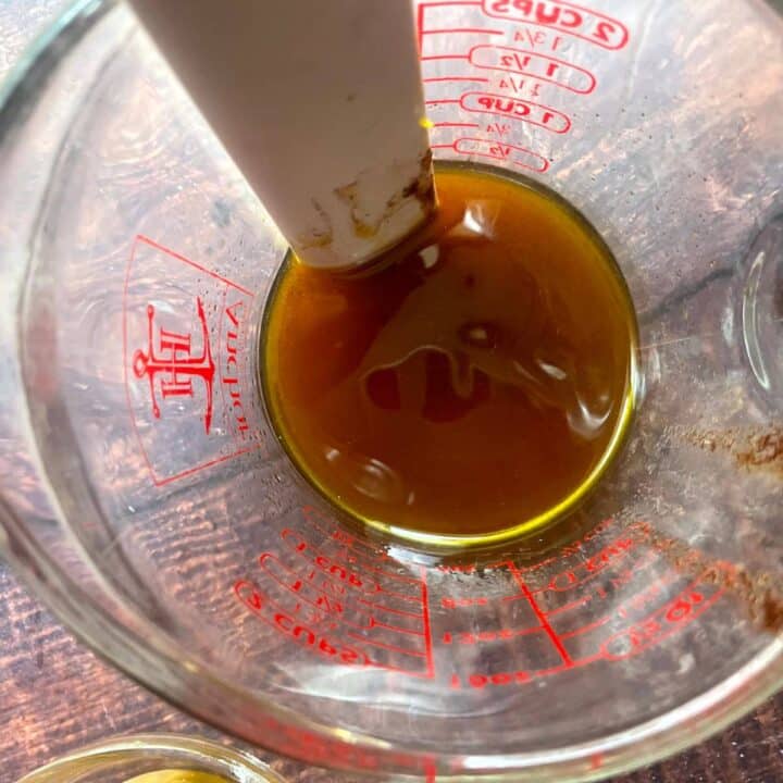 A measuring cup filled with a brown liquid.