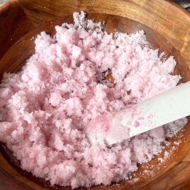 Peppermint foot scrub with sugar in a wooden bowl.