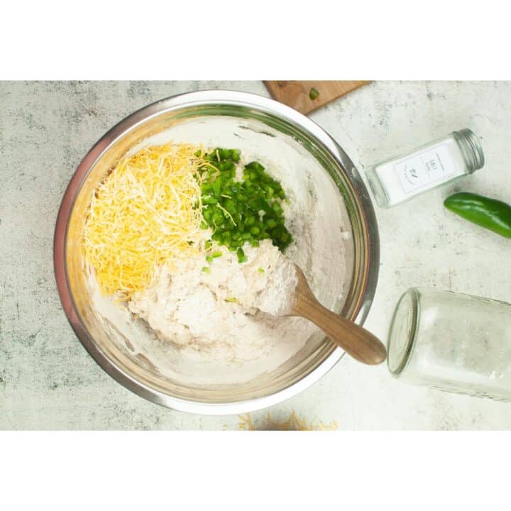 A bowl full of ingredients for a cheesy nachos.