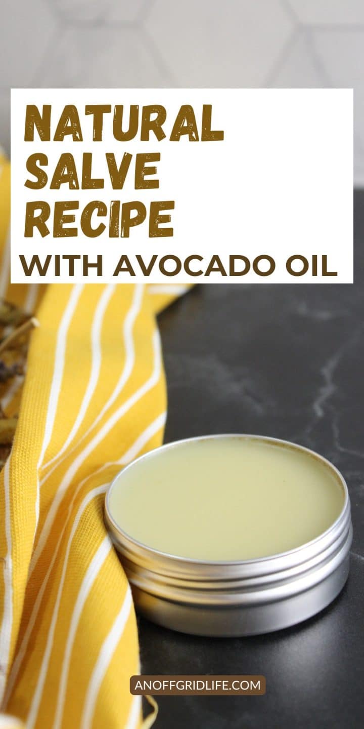Tin of salve next to a yellow striped cloth, with a sign reading "Natural Salve Recipe with Avocado Oil.