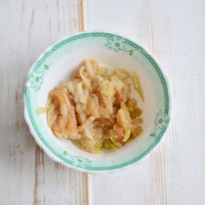 Shredded apples in a bowl for No Cook Cranberry Relish Recipe.