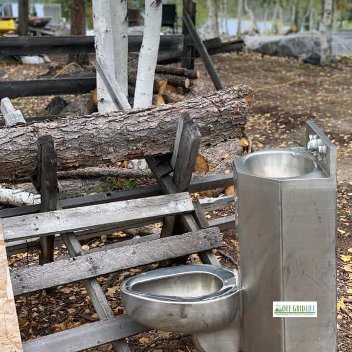 An off grid toilet in a wooded area.