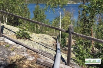 Our diy off grid water supply system above ground pipe going over rock down to the lake