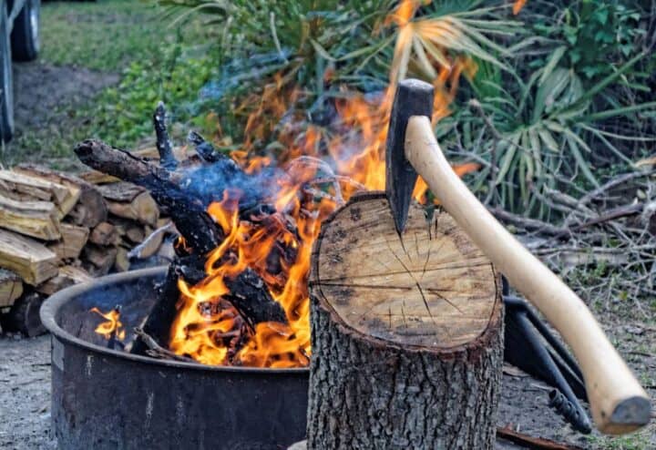 Outdoor fire with axe in stump