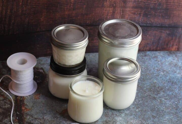 Three homemade emergency candles and a spool of wicking.