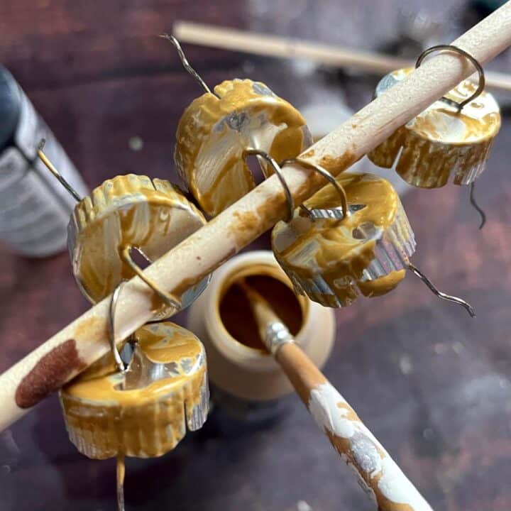 A bunch of yellow and brown paint on a wooden stick.