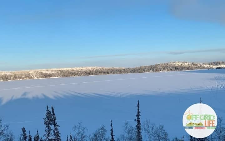 Winter View of snow covered lake with hills in the distance