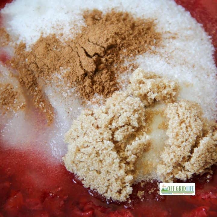 Strawberries, white sugar, brown sugar, cinnamon in a bowl