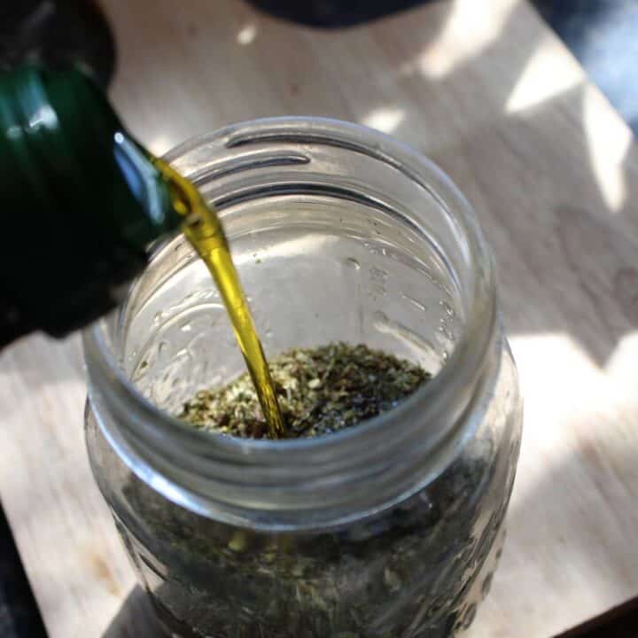 Pouring oil into oregano flakes