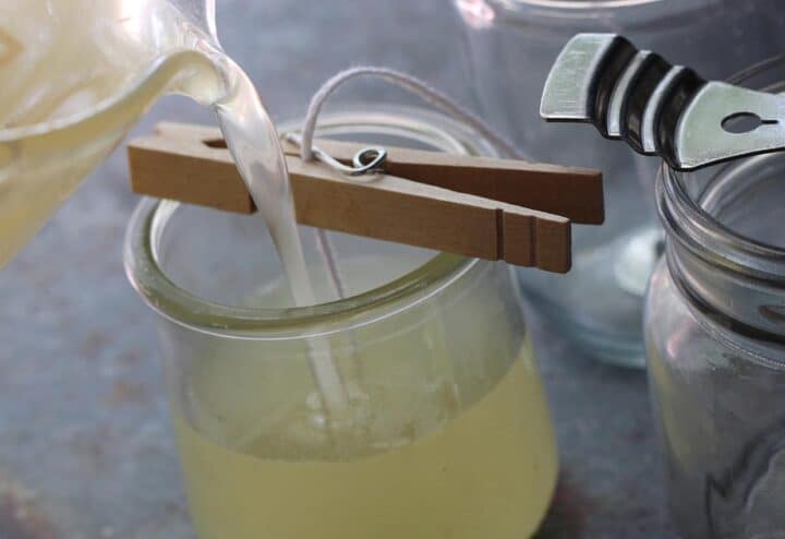 Pouring soya wax into candle jars.