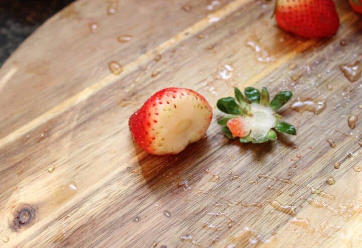 Prepping fresh strawberries for jam.
