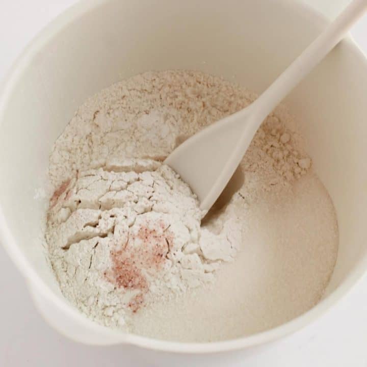 Flour and egg in mixing bowl to make pumpkin cinnamon roll skillet cake recipe