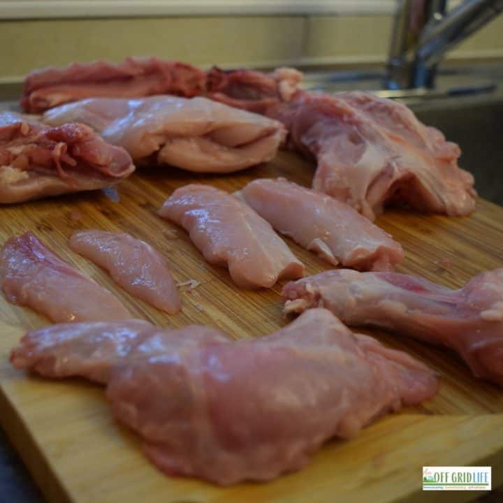 a picture of a fully butchered rabbit on a wooden cutting board