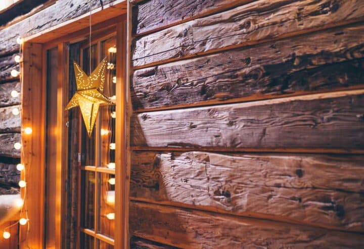 A rustic Christmas decor idea; a wooden window frame with a star hanging from it.