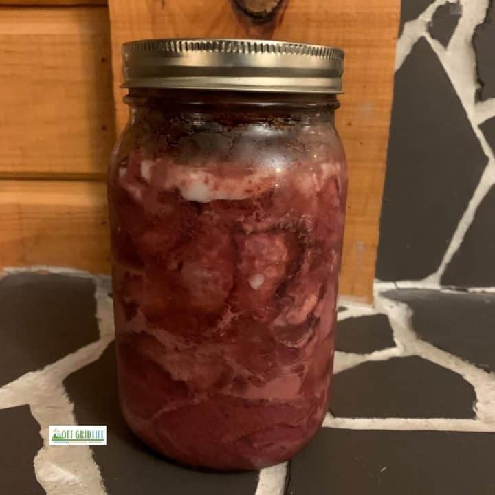 Canned moosemeat in a mason jar.