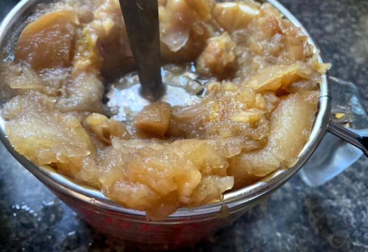 Applesauce in a jar with a spoon.