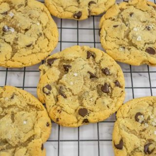 A group of sourdough discard chocolate chip cookies on a wire rack.