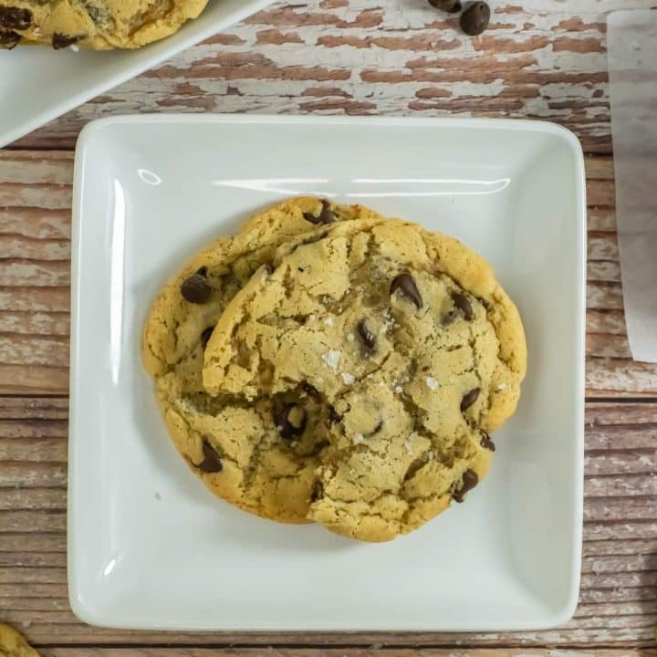 A plate of sourdough chocolate chip cookies on a table.