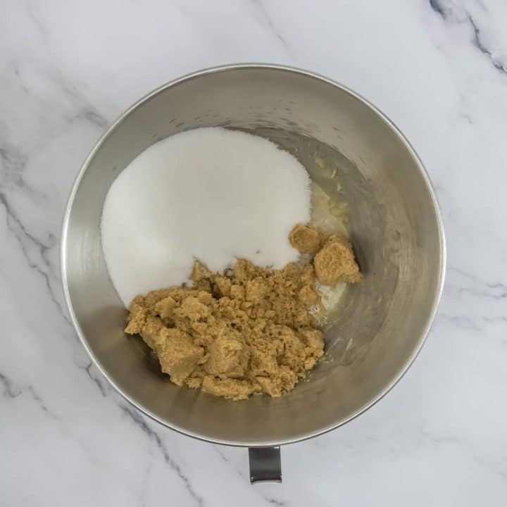 A bowl of brown sugar and white sugar.