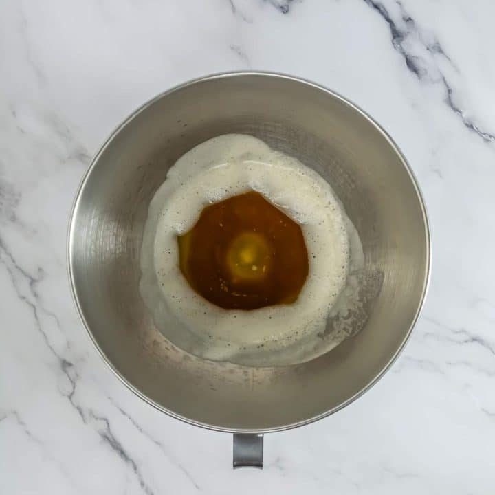 A mixing bowl with a mixture of eggs and a yolk.