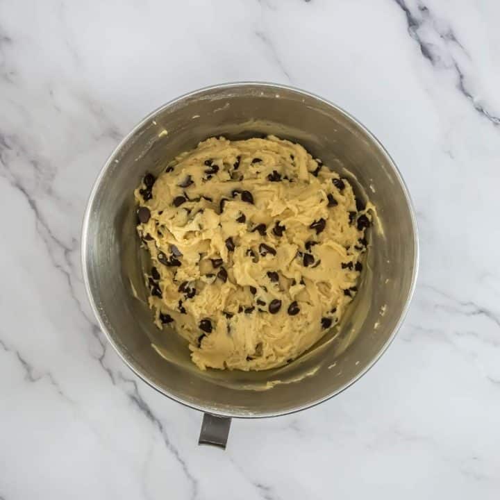 Chocolate chip cookie dough in a mixing bowl.