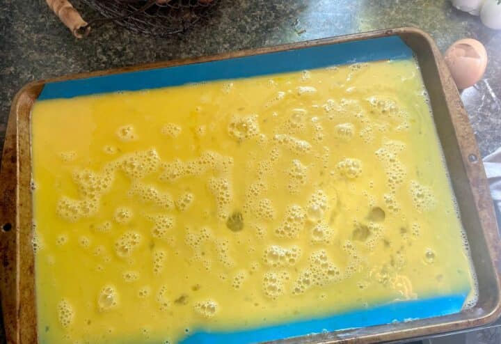 Spreading raw eggs on silicone mat