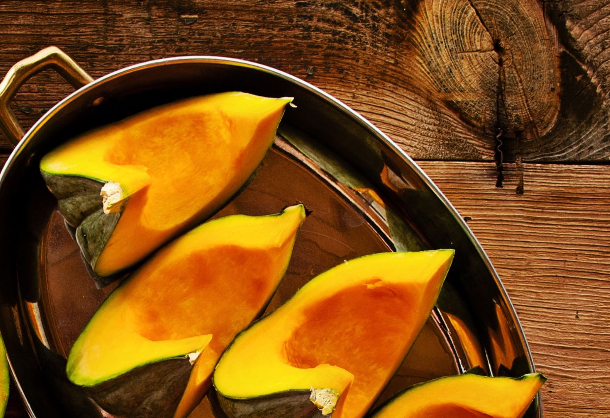 A plate of sliced pumpkins on a wooden table.