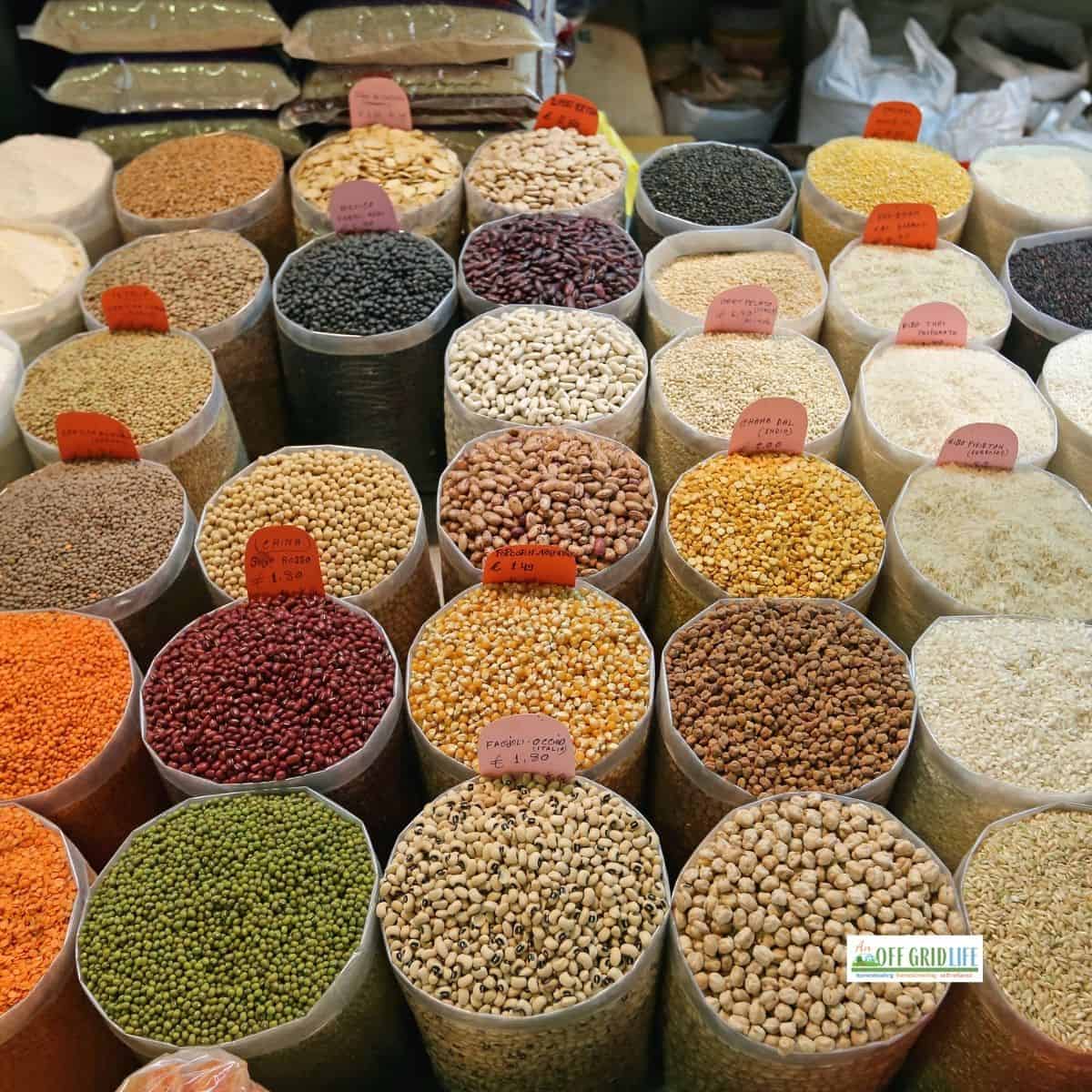 Dried goods in pails at a market.