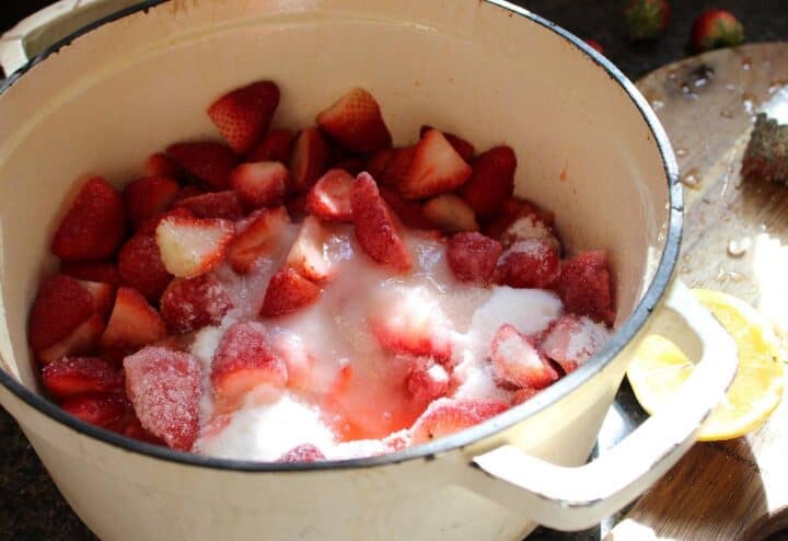 Sugar and sliced fresh strawberries in heavy pot.