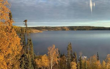 Autumn View of trees changing color and lake in background - why we live off the grid in the subarctic