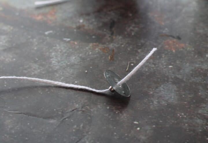 Wick and metal sustainer tab for candle.