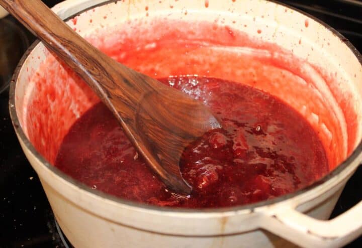 Wooden spoon in homemade strawberry jam