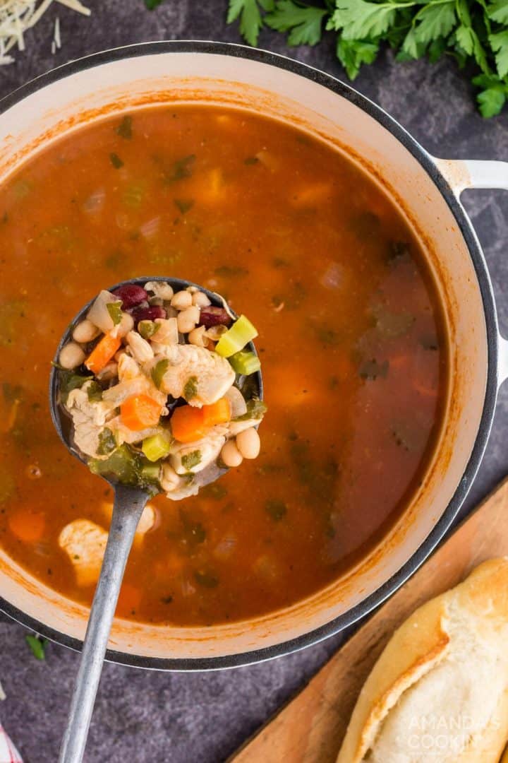 A delicious chicken and bean soup in a Dutch oven.