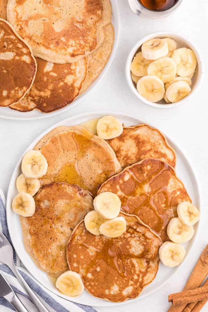 cinnamon banana pancakes on white plates