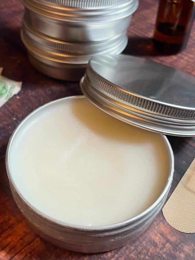A tin of beeswax on a wooden table.