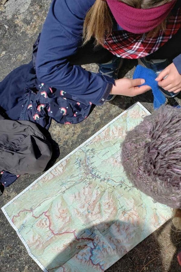 kid studying map