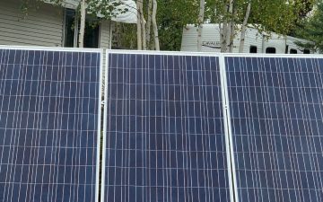 Solar panels on a frame at ground level generating Off grid electricity