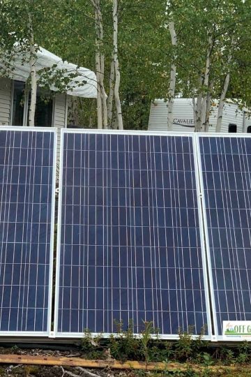 Solar panels on a frame at ground level generating Off grid electricity