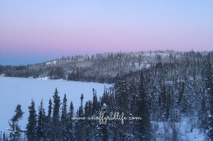 This is the view from our off grid home. Sticking to our off grid home winter routine helps our family survive the frigid temperatures in Canada's far north. Here's what we do each day to keep things going. #offgridhomes #offgridhacks #offgridlife