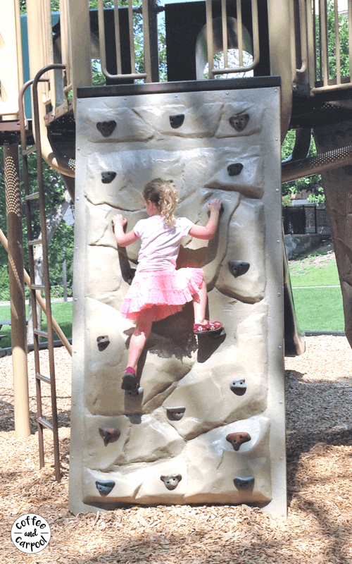 girl on climbing wall at park