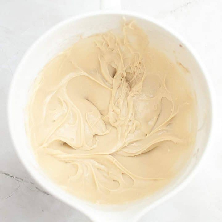 Whipped coffee mixture in a cup viewed from above.