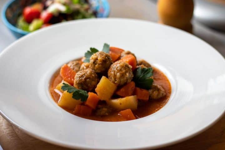 meatball soup in white bowl